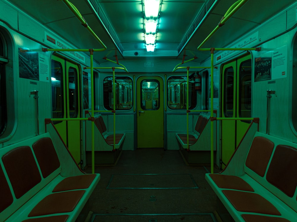 a subway car with red seats and a green door