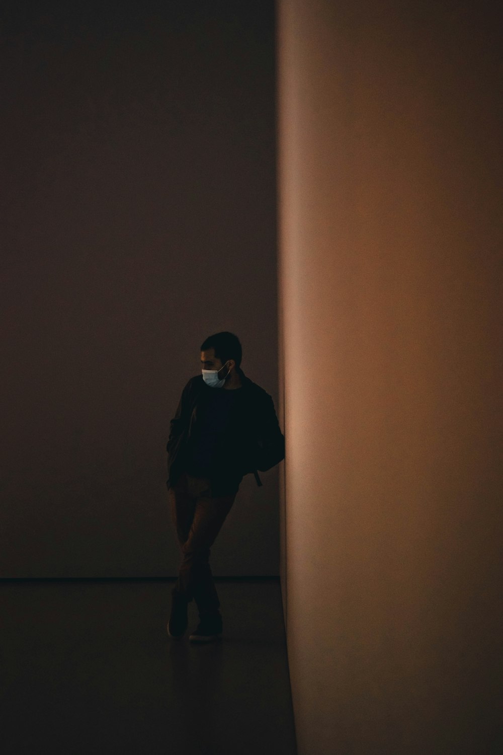 a woman wearing a face mask in a dark room