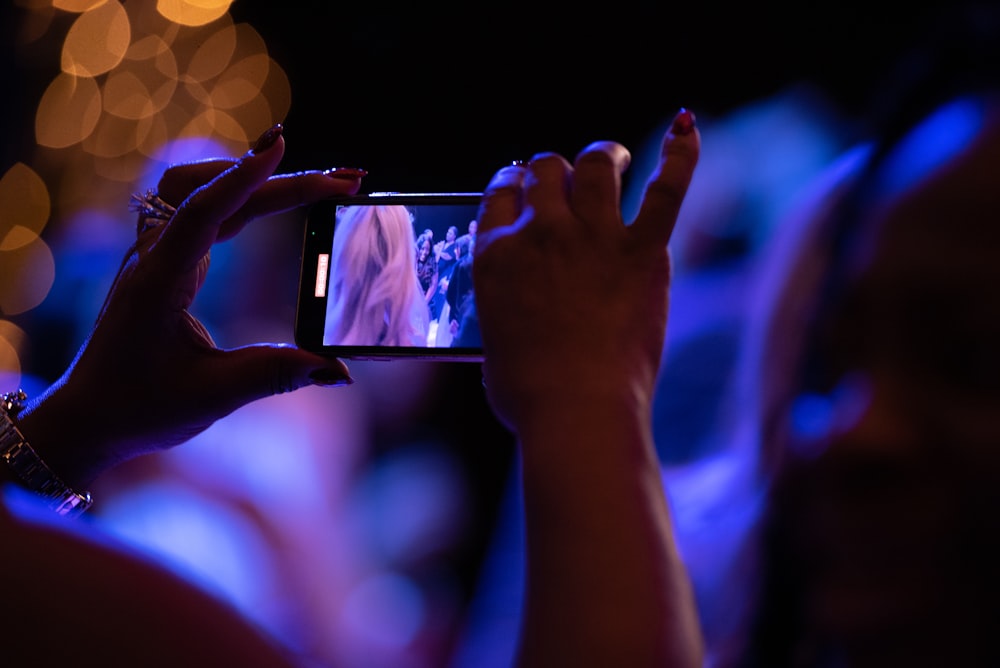 a person taking a picture with a cell phone