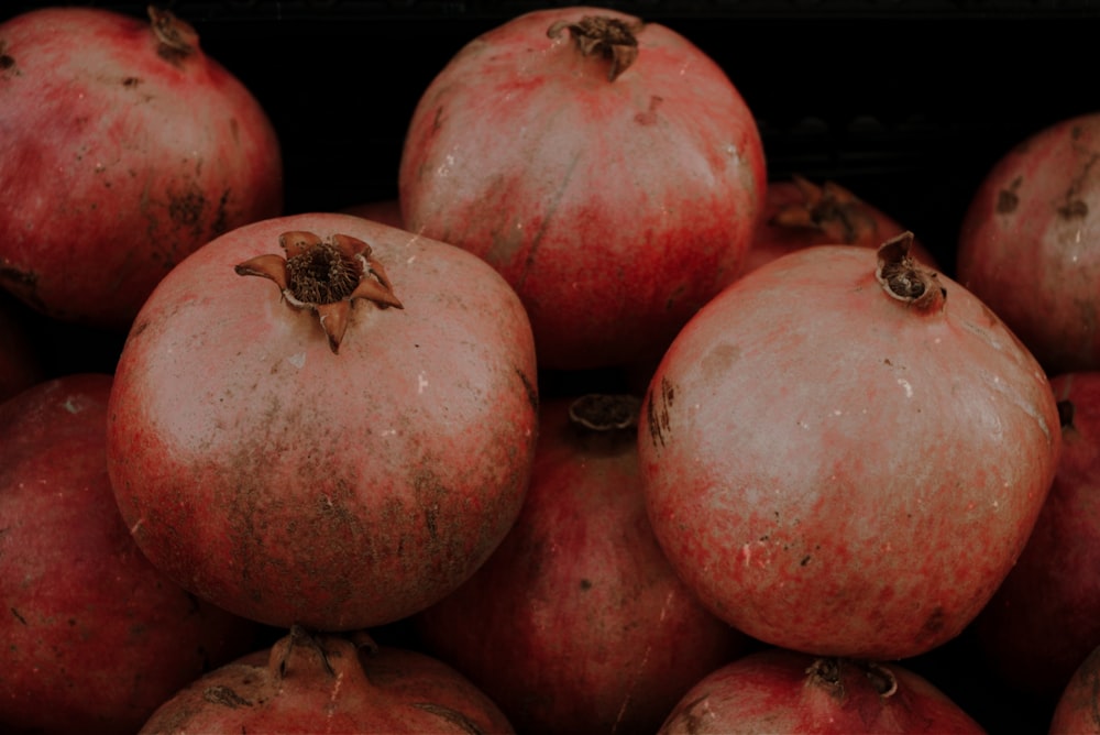 a pile of pomegranates sitting on top of each other