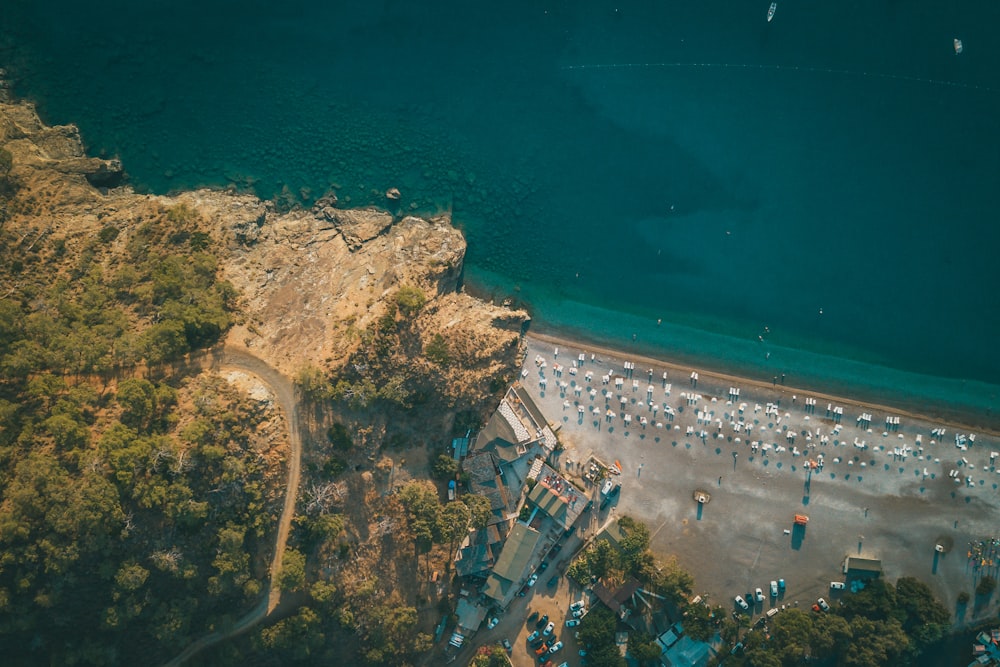 an aerial view of a parking lot next to a beach