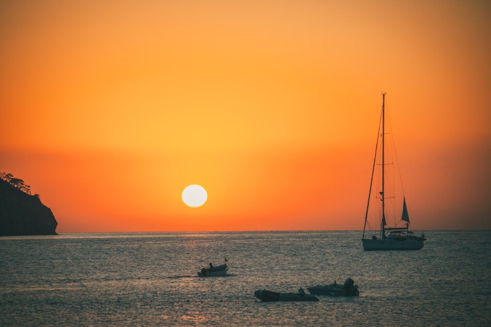 a couple of boats floating on top of a body of water