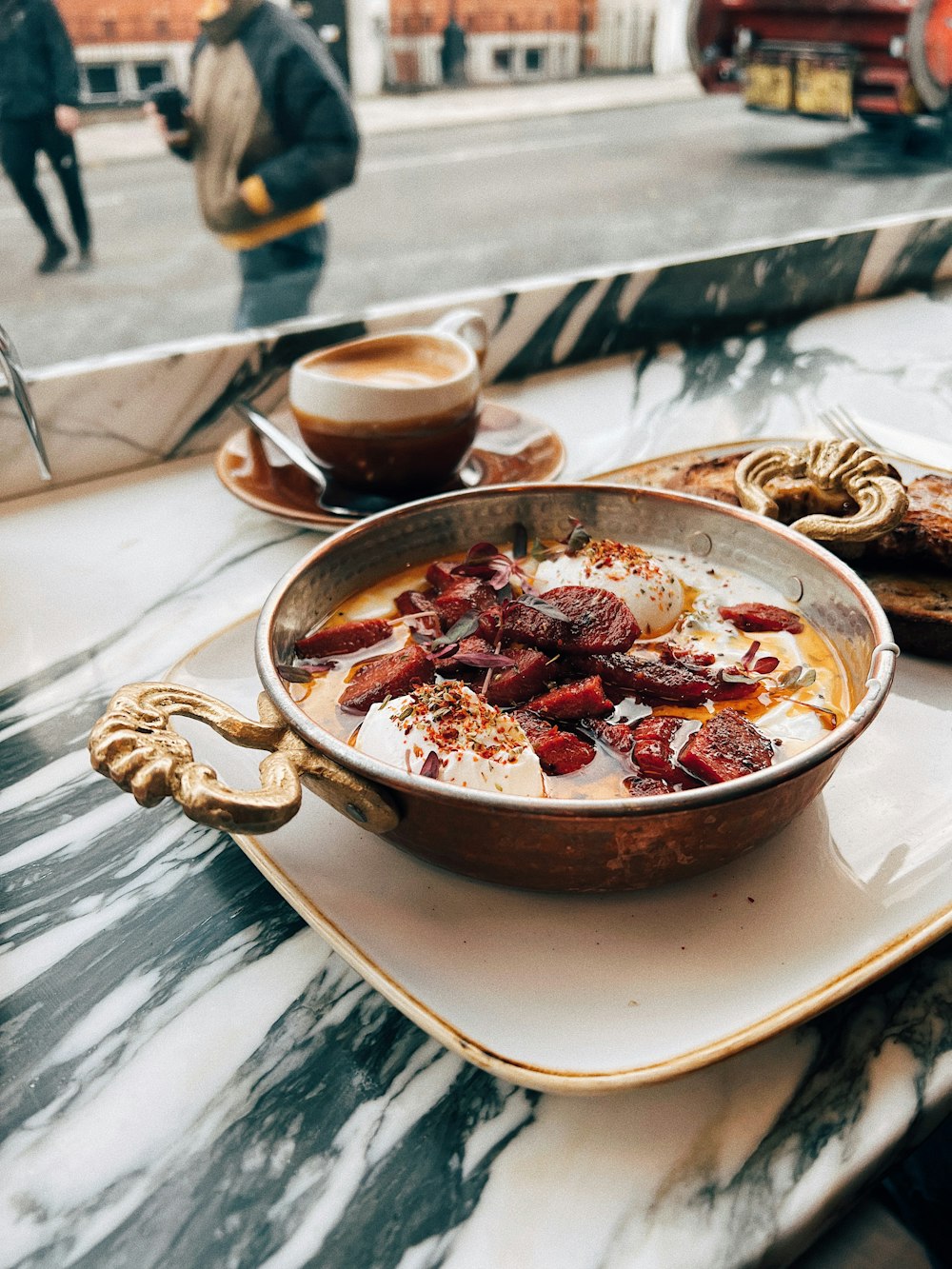 a bowl of food sitting on top of a white plate