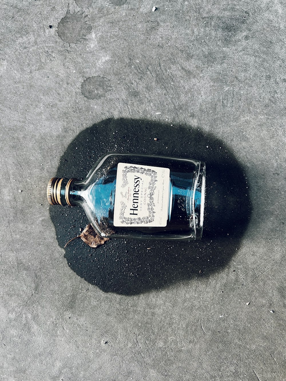 a bottle with a label on it sitting on the ground