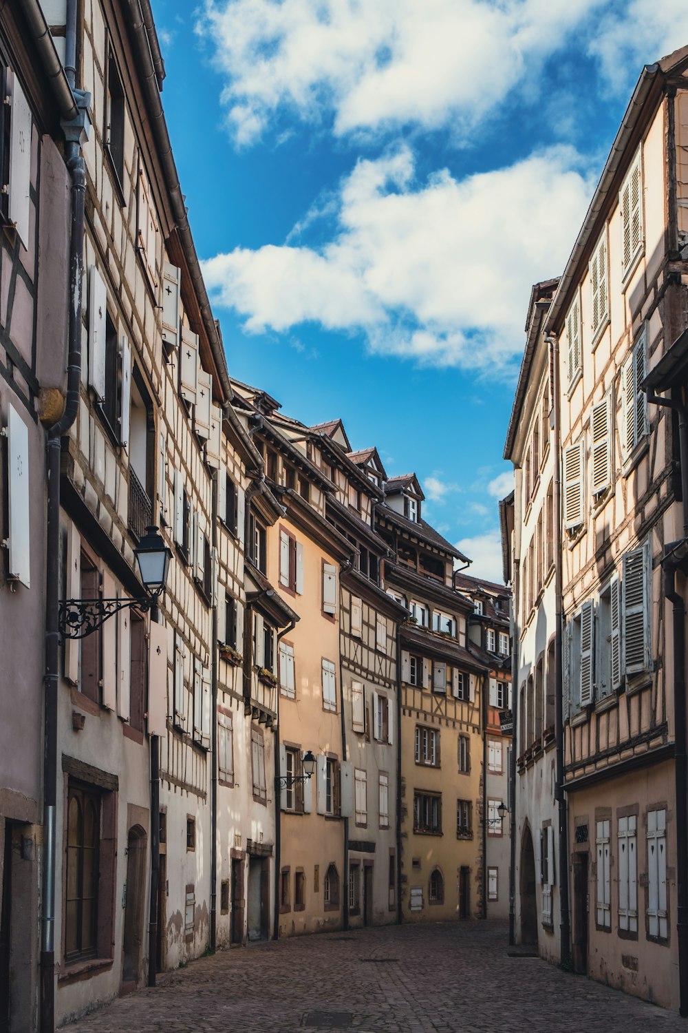 a cobblestone street lined with old buildings