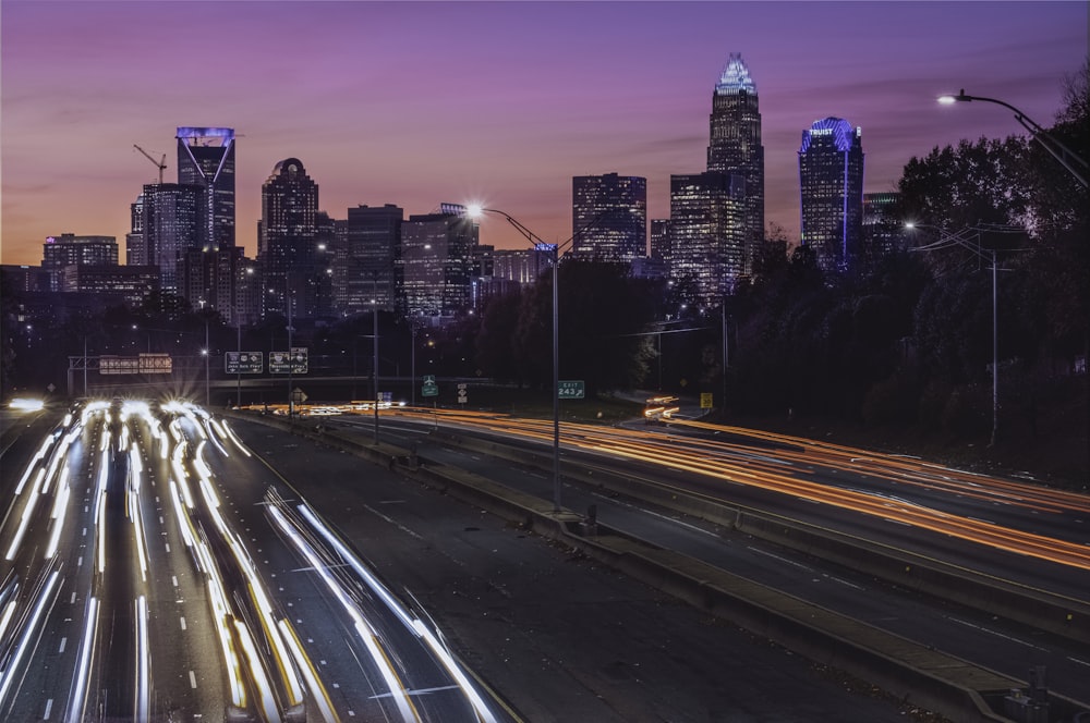 a city skyline at night with a lot of traffic