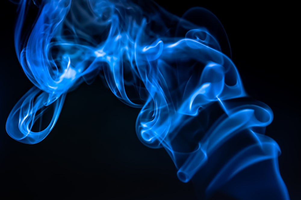 a close up of blue smoke on a black background