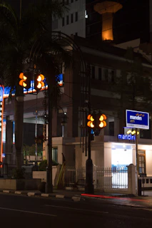 An ATM machine installed at a busy urban corner with people using it.