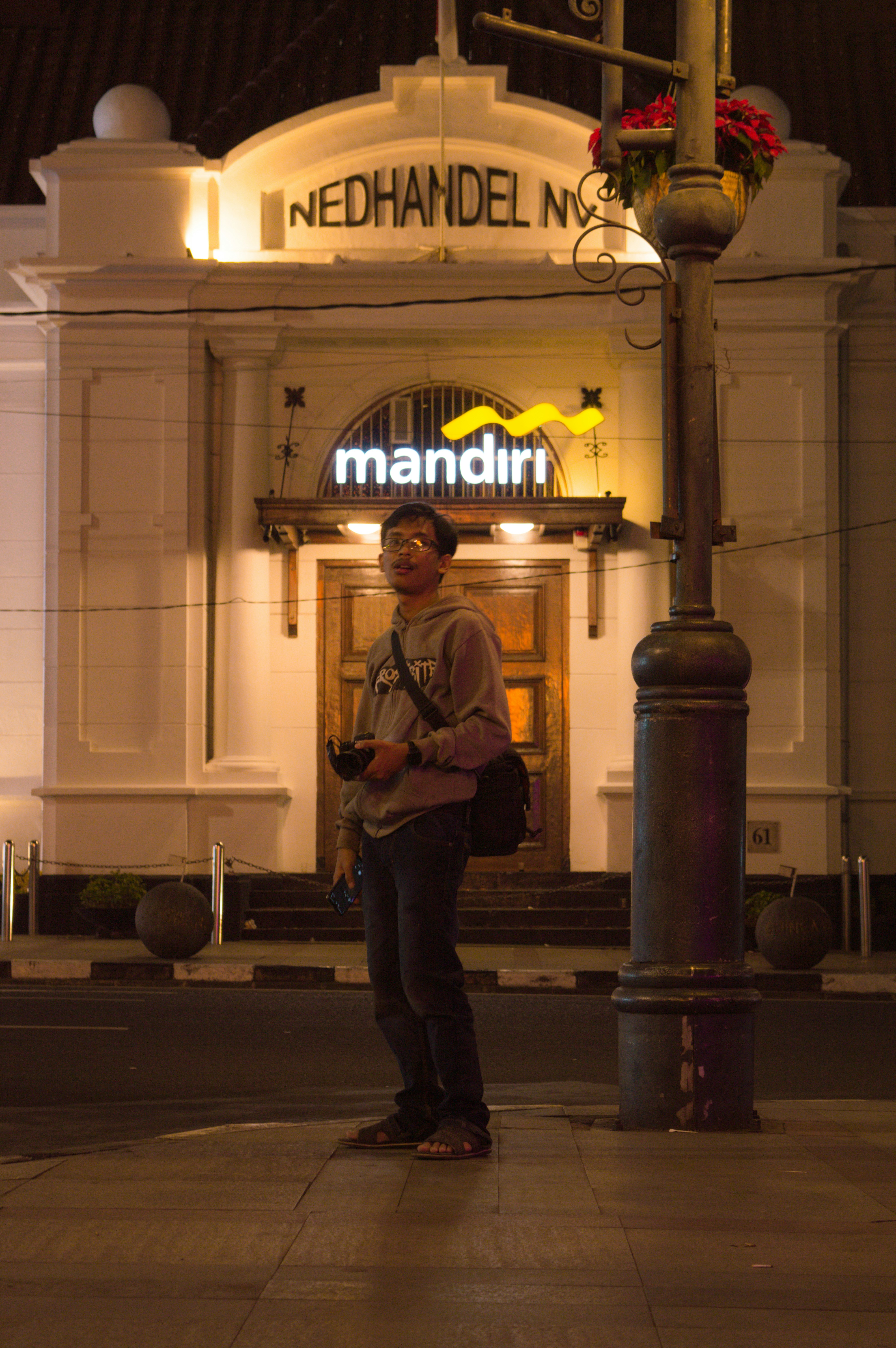 a man standing in front of a building at night