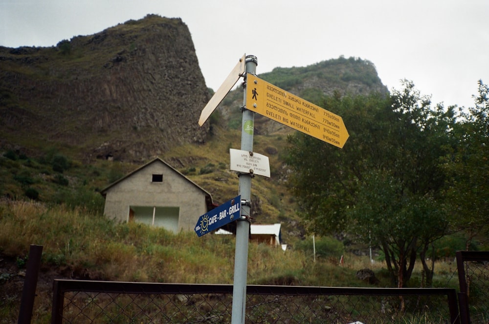 a street sign with a mountain in the background