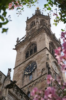 a tall clock tower with a clock on each of it's sides