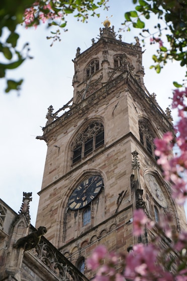 a tall clock tower with a clock on each of it's sides