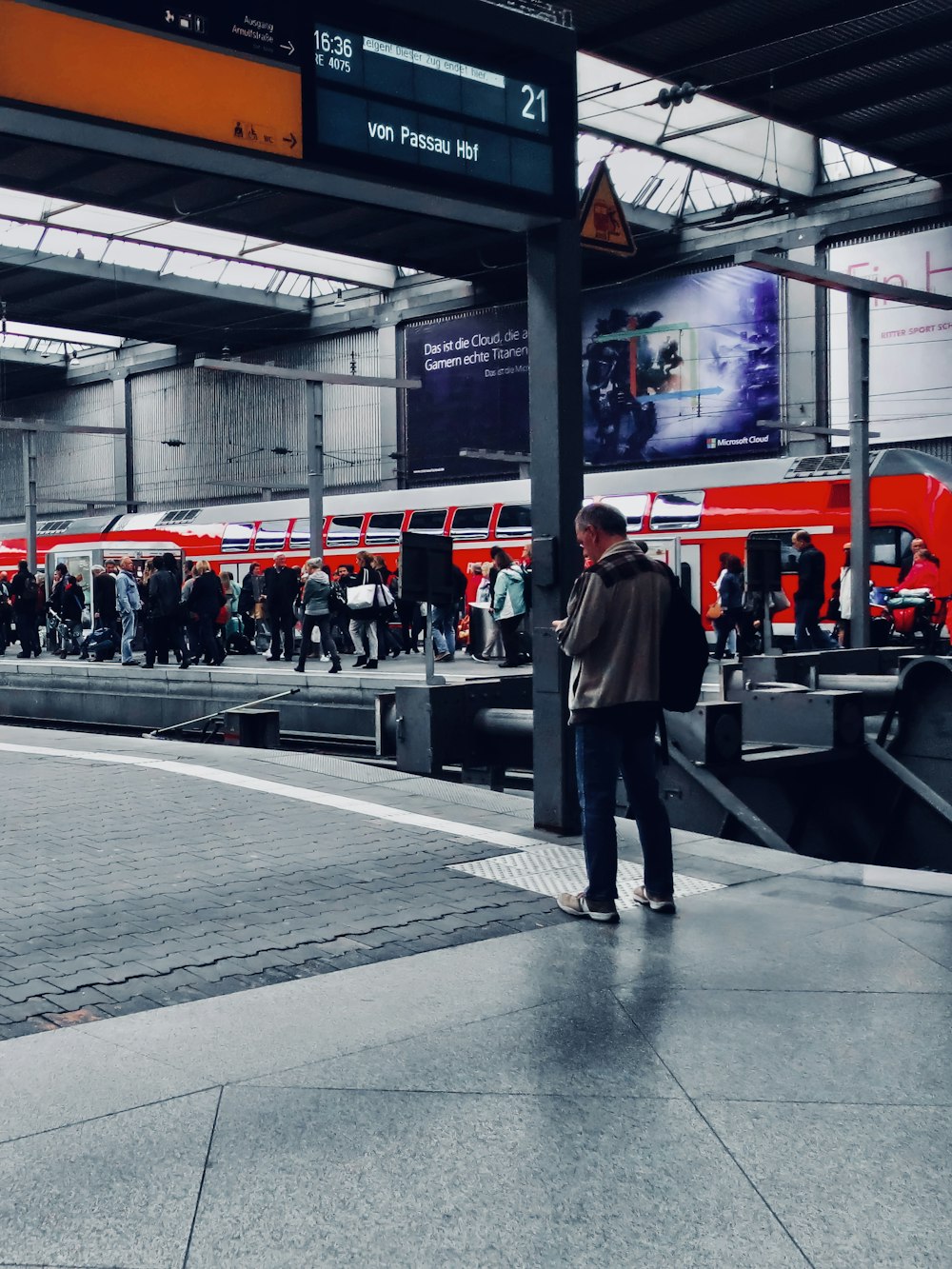 a group of people standing around a train station