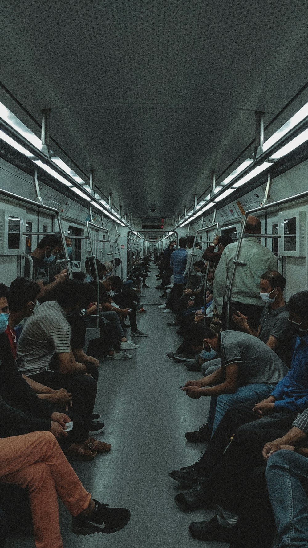 a group of people sitting on a subway train