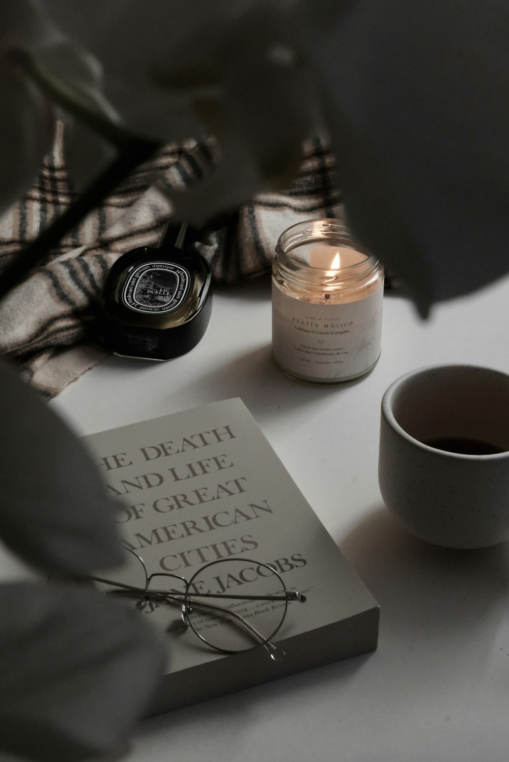 a candle and a book on a table