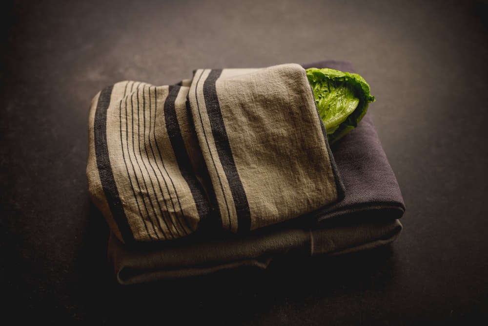a towel with a green leaf on top of it