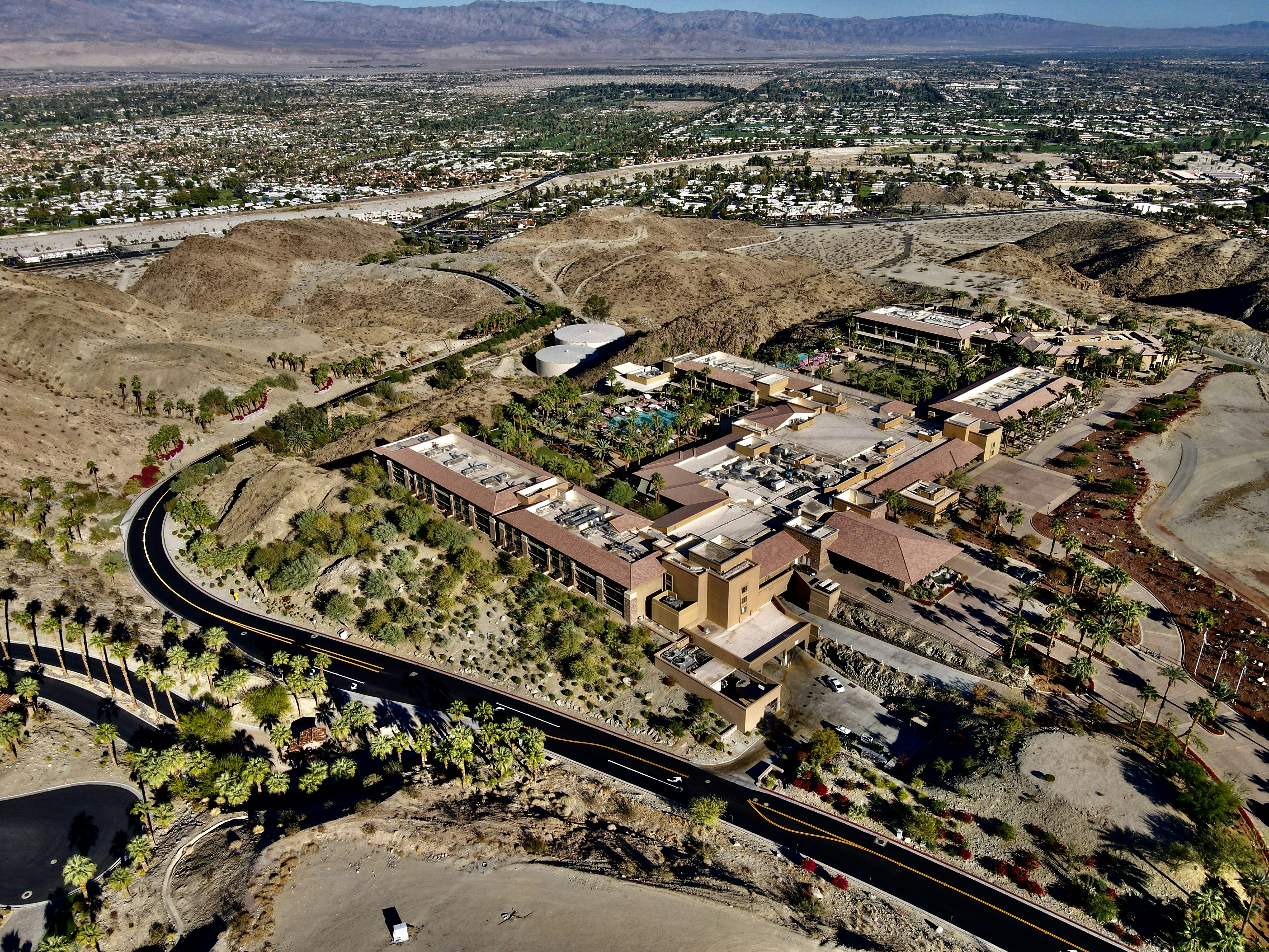 an aerial view of a large building surrounded by mountains