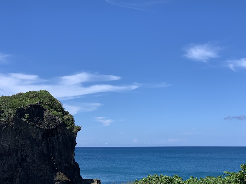 a large rock outcropping next to a body of water