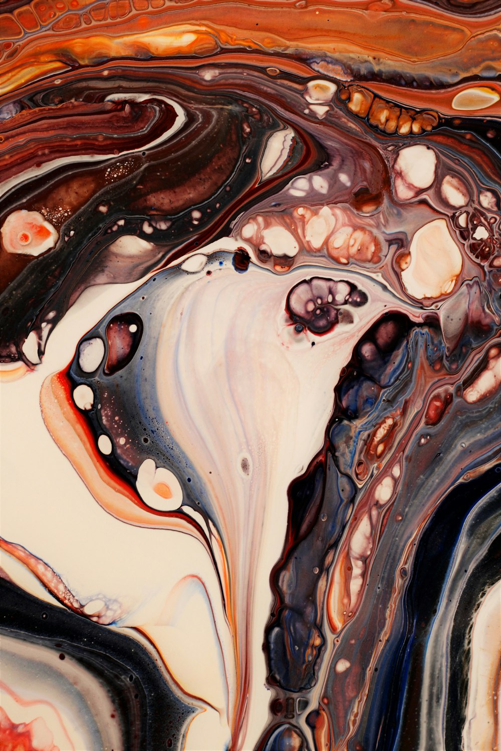 a close up of an abstract painting with black, brown, and white colors