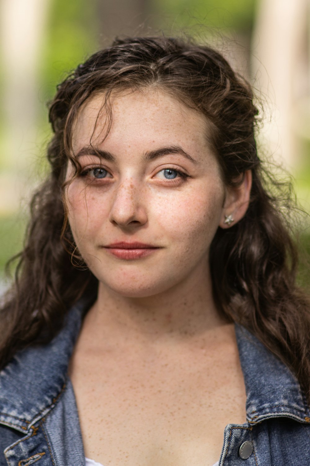 a close up of a person wearing a jean jacket