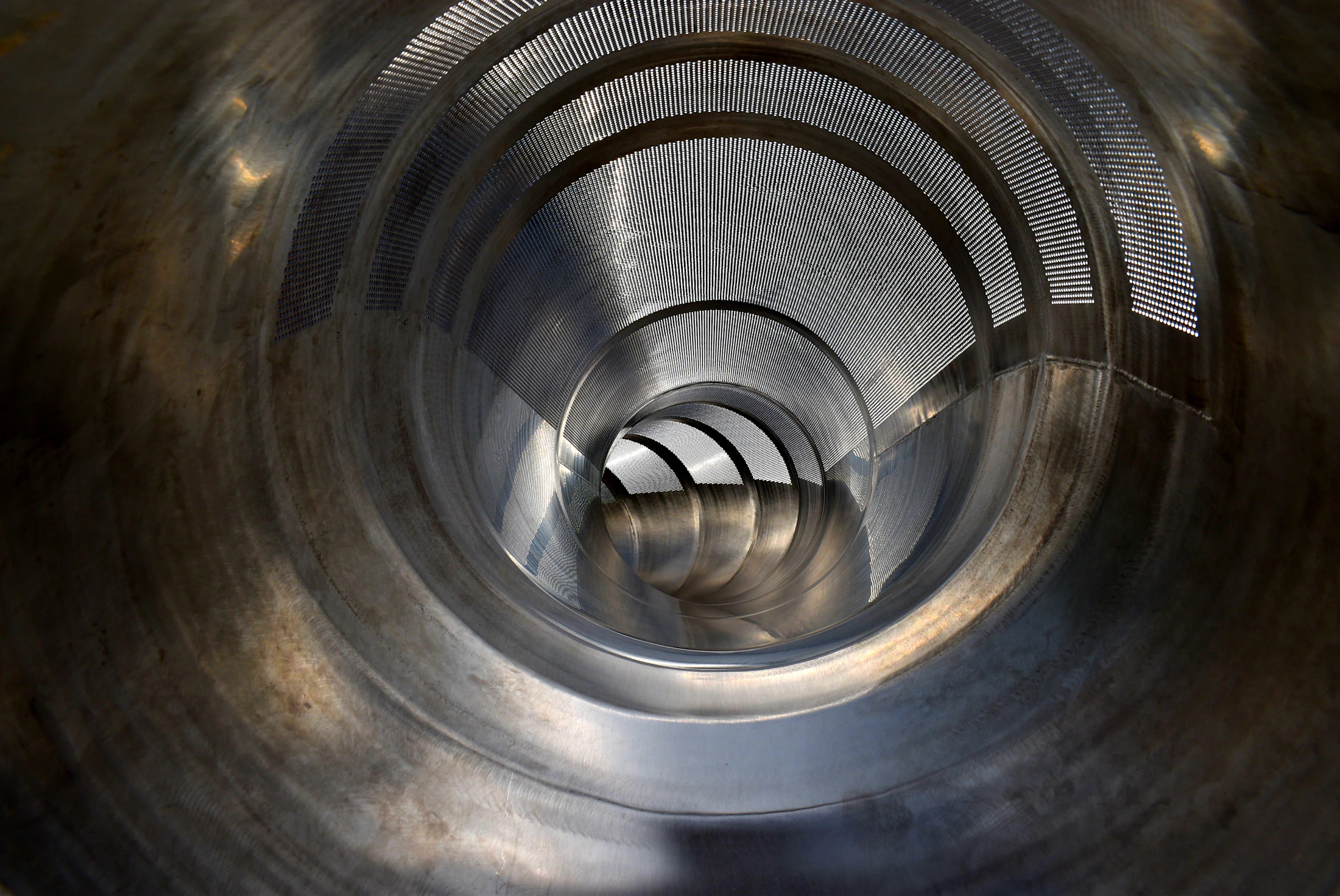 Polished stainless steel round pipe with hollow opening visible