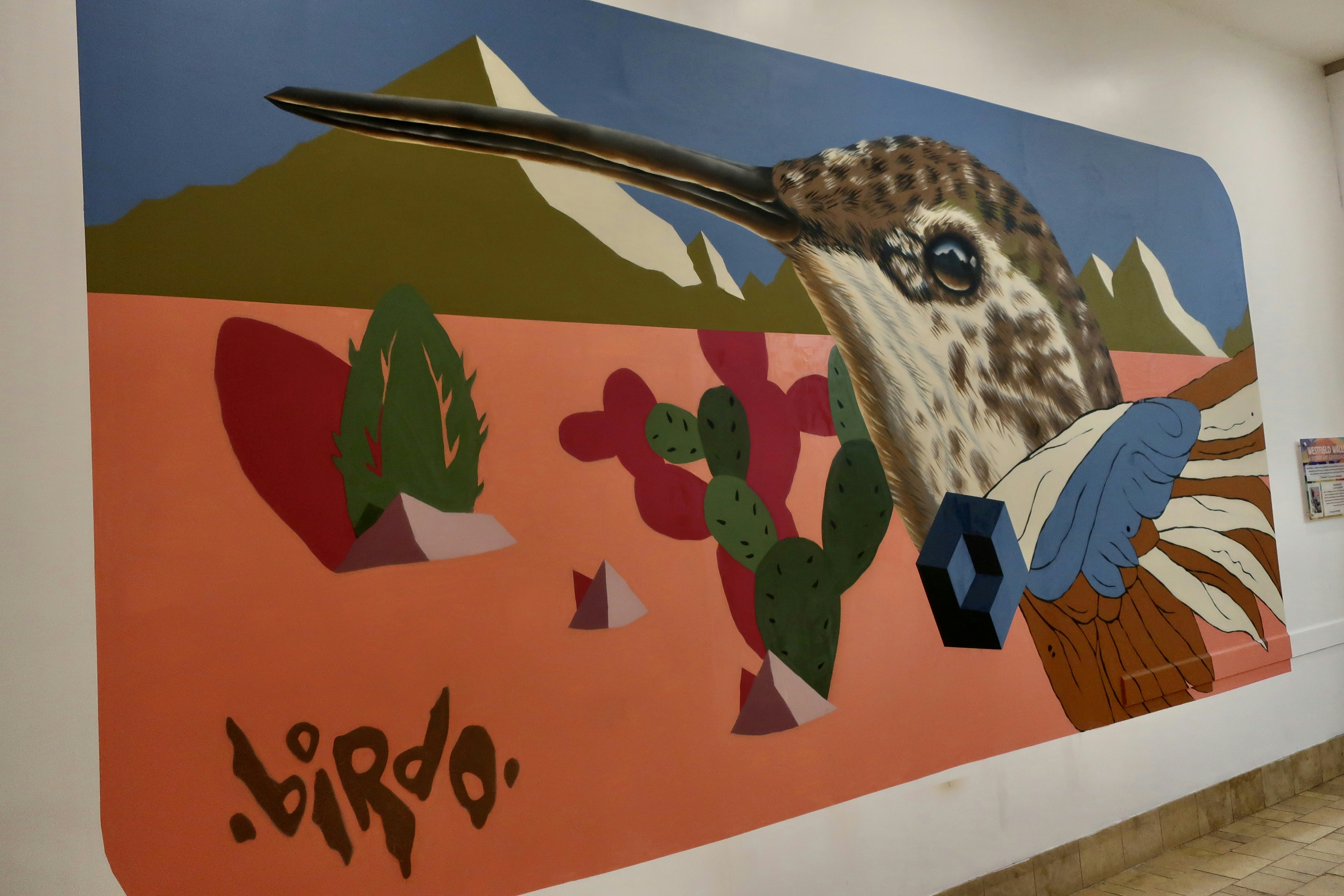 a painting of a bird on a wall