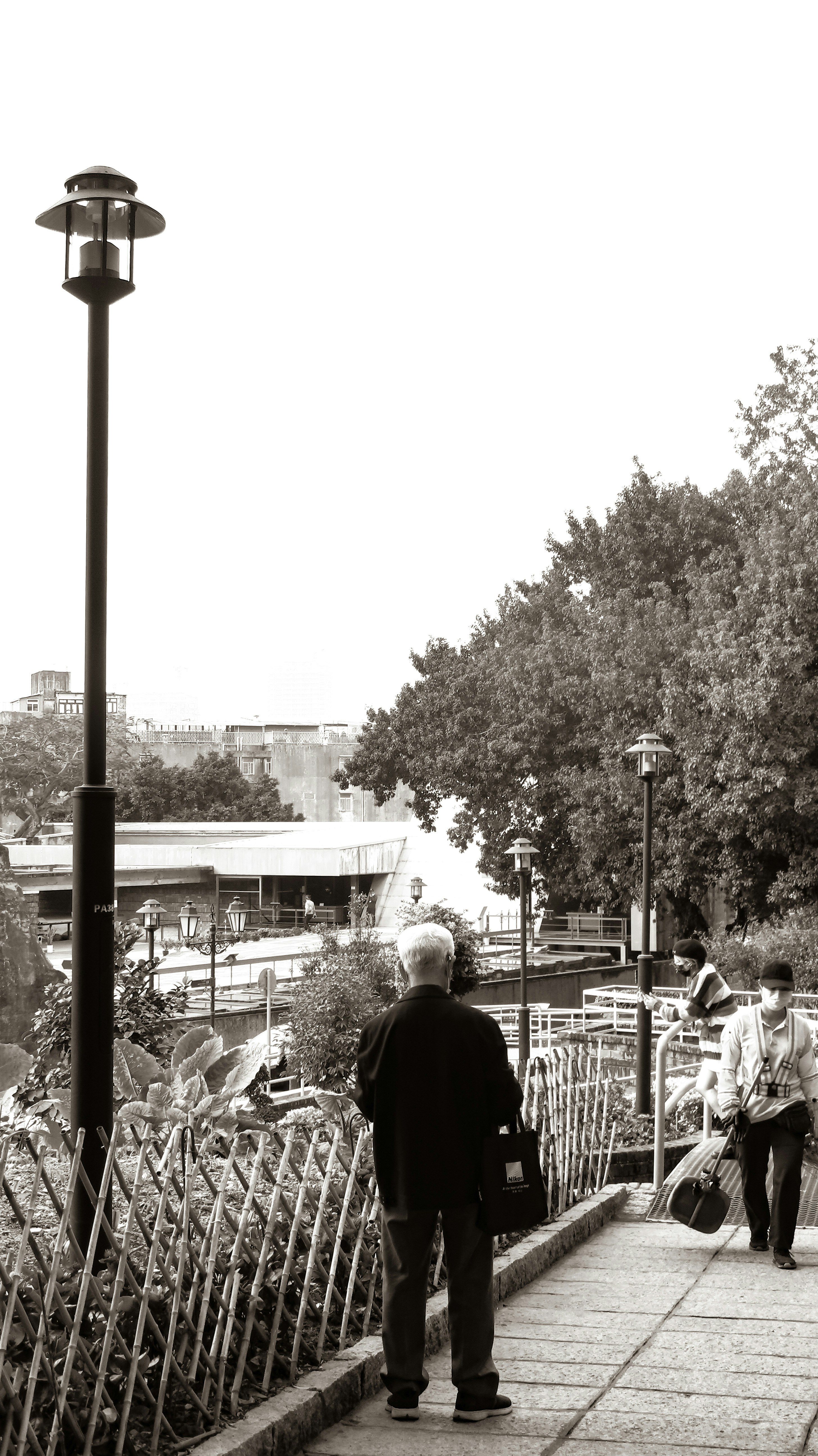 A group of people walking across a bridge photo – Free Person Image on ...