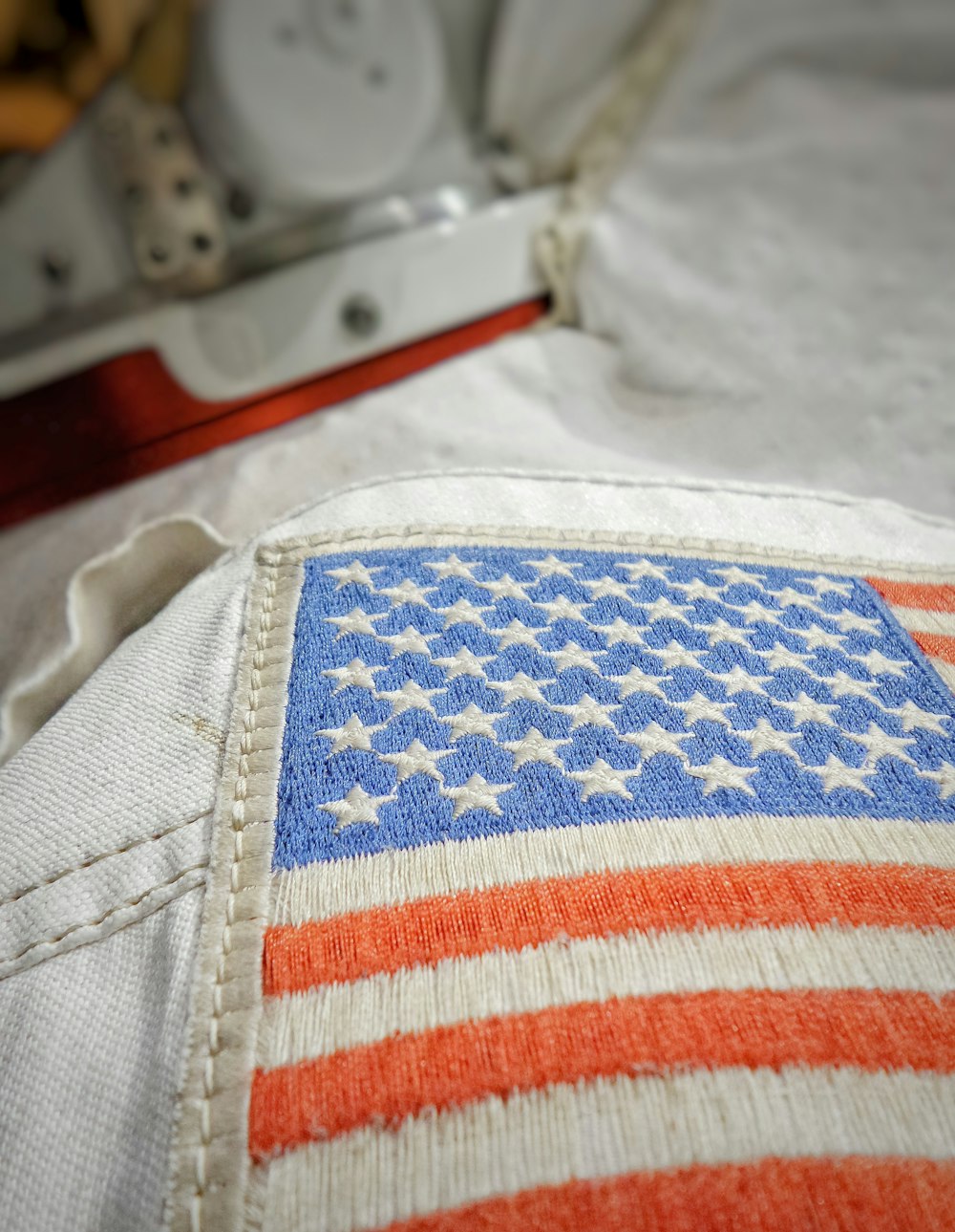 a close up of an american flag on a bed