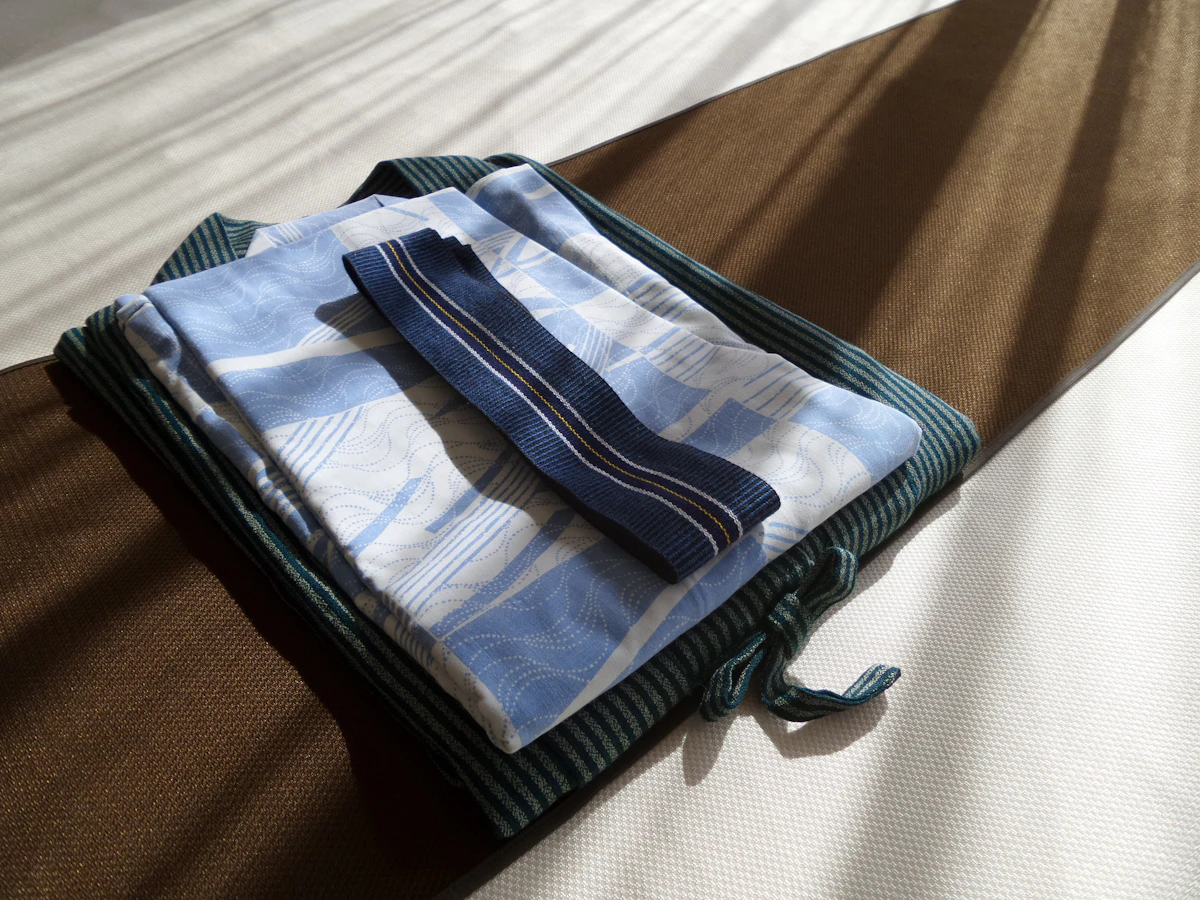Neatly folded lightweight towels stacked on a bed