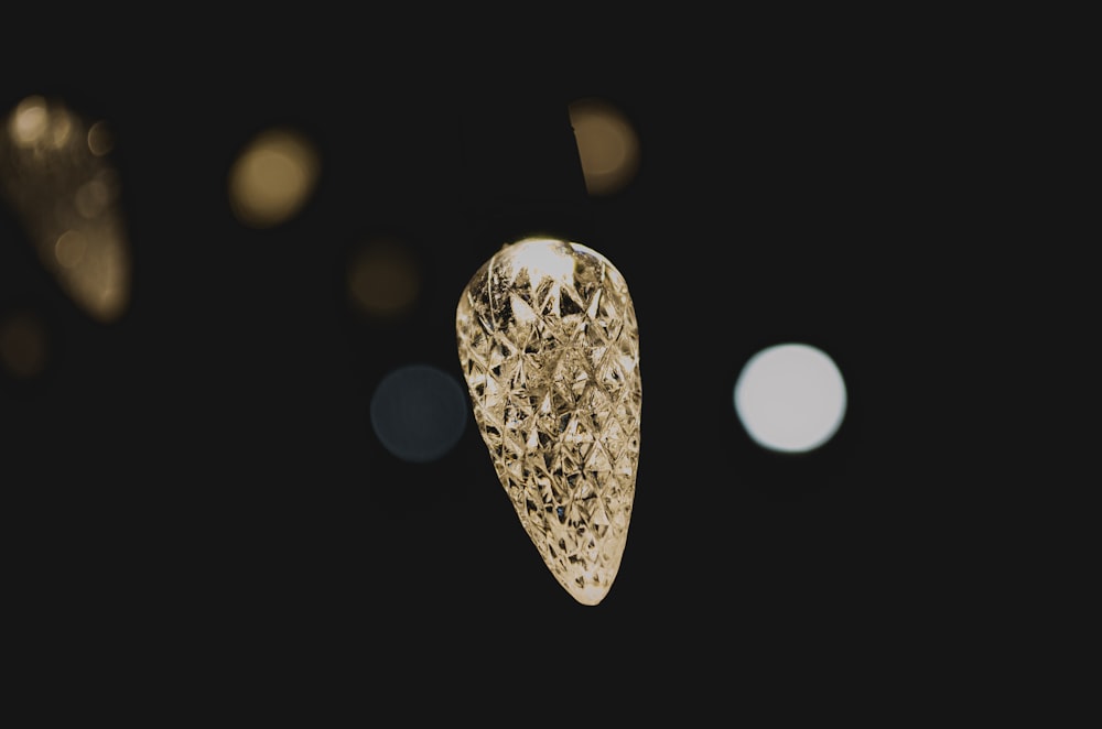 a close up of a gold ring on a black background