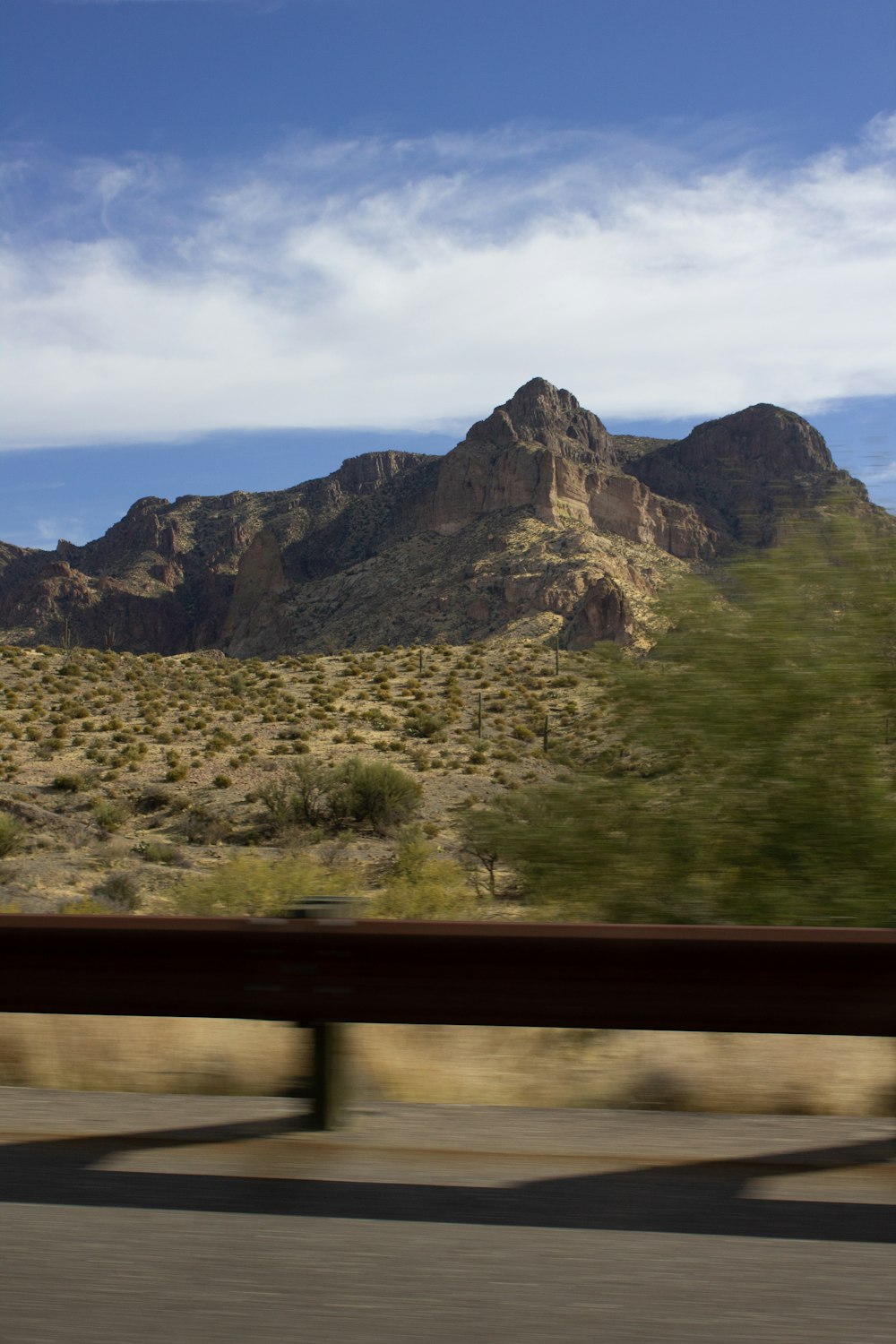 a view of a mountain from a moving car