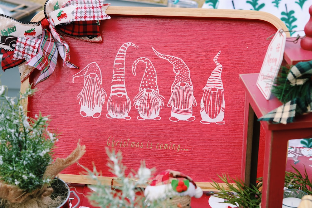 a red wooden sign with white designs on it