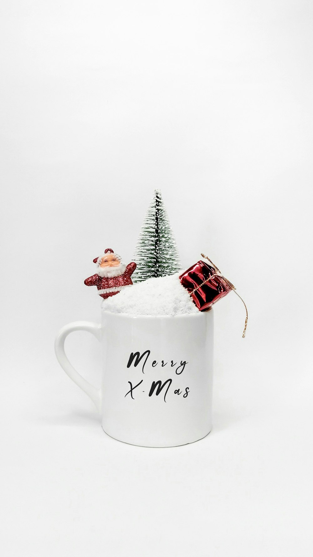 a white mug with a christmas tree in it