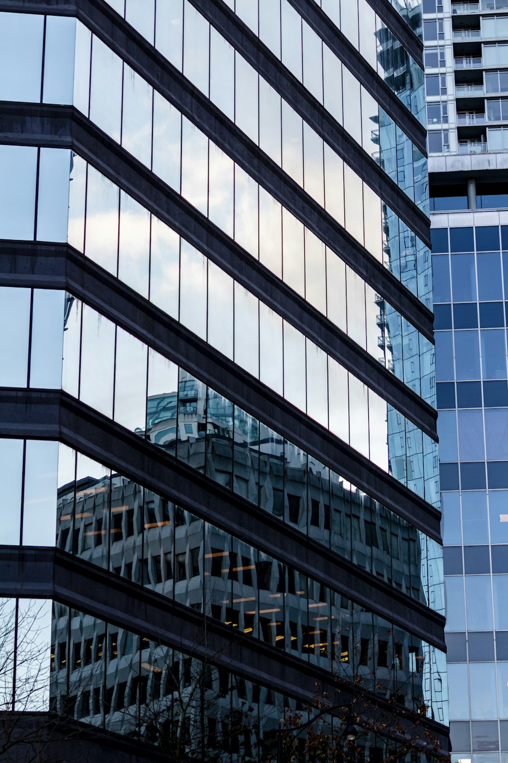 the reflection of a building in the windows of another building