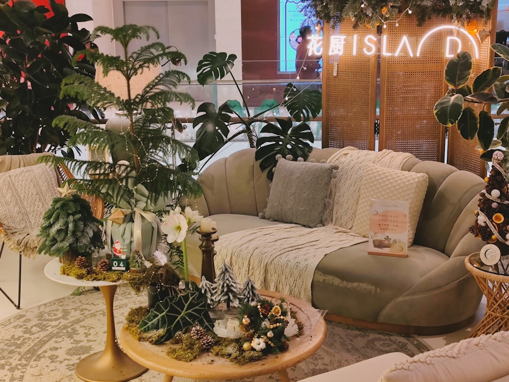 a living room filled with lots of furniture and plants