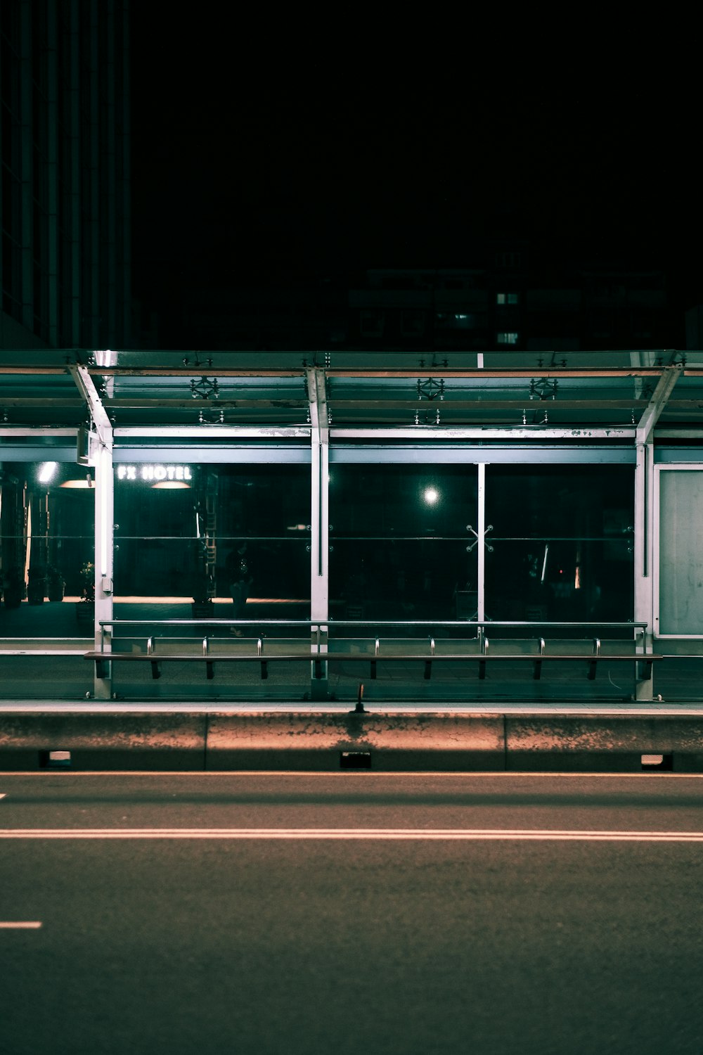 a bus stop at night with lights on