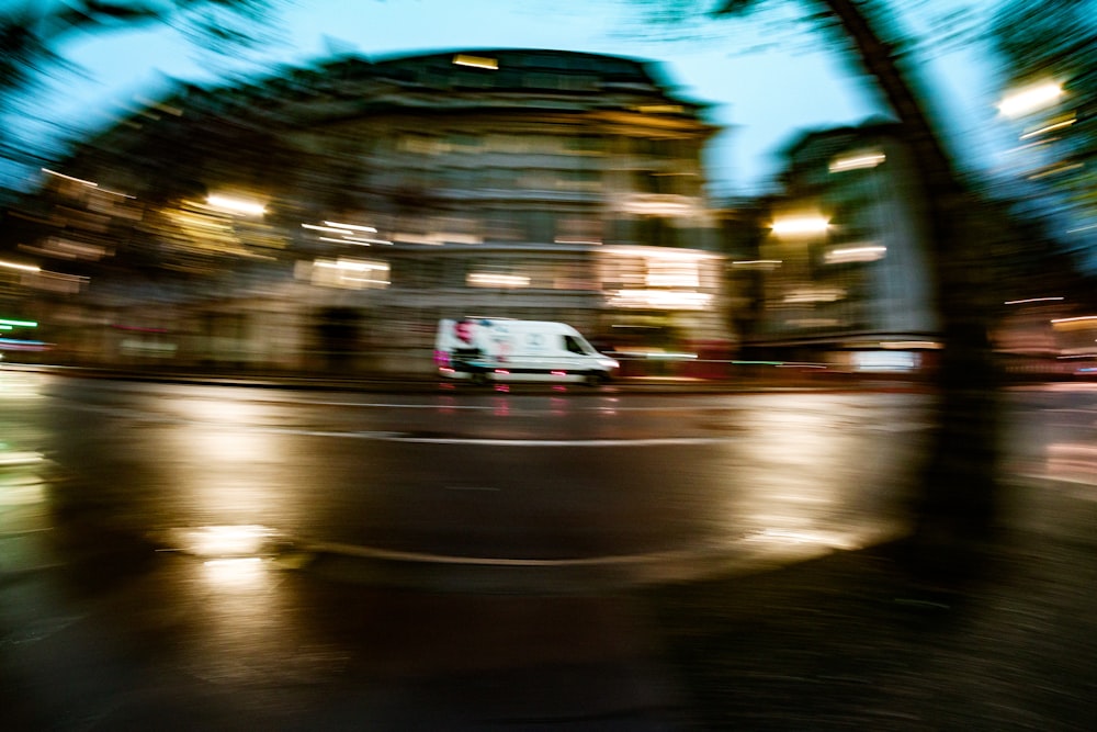 a blurry photo of a van driving down a street