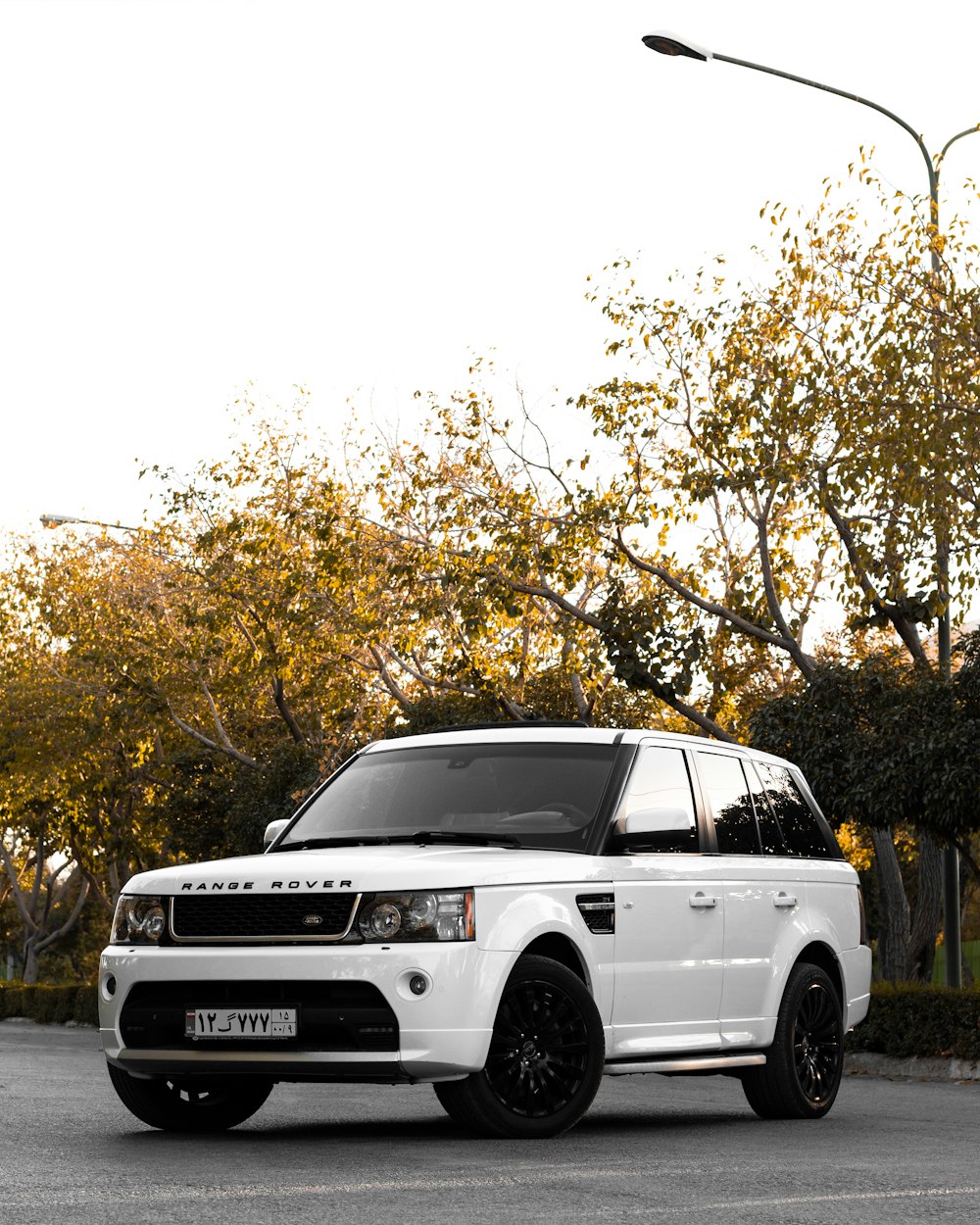 a white range rover parked in a parking lot