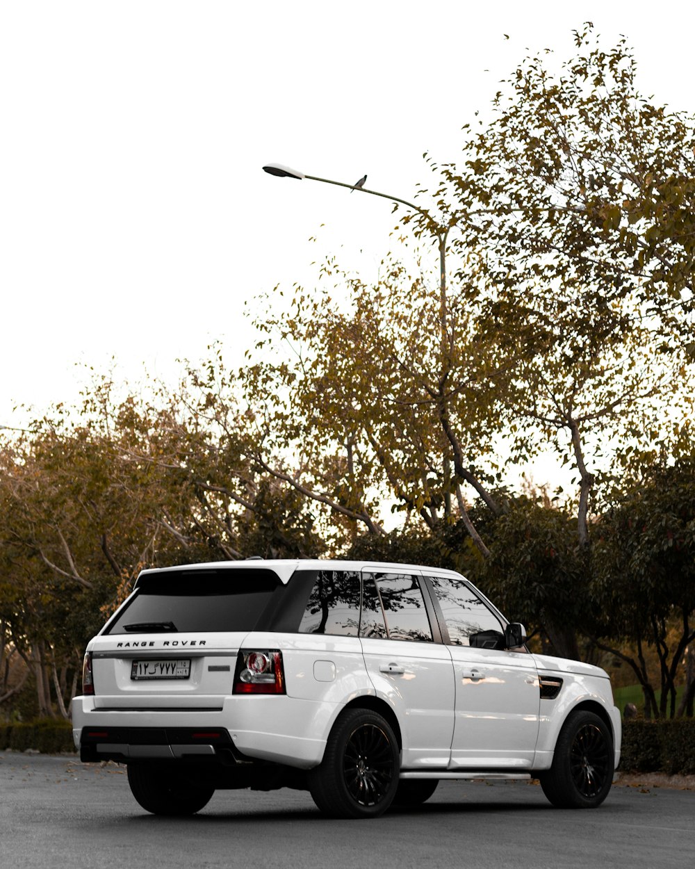 a white range rover parked on the side of the road