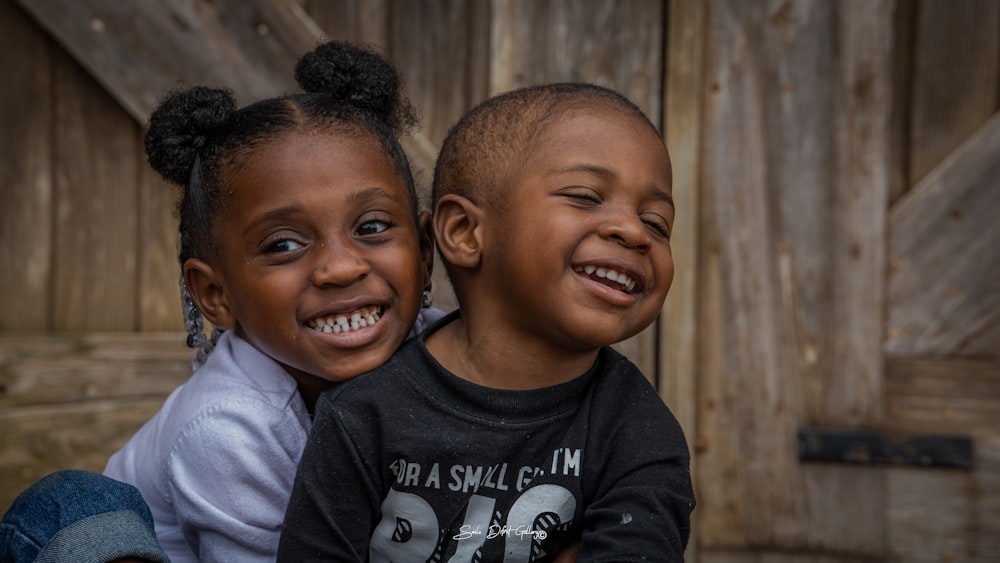 a couple of kids sitting next to each other