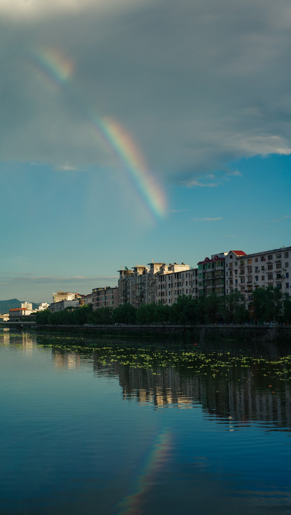 a rainbow in the sky over a body of water