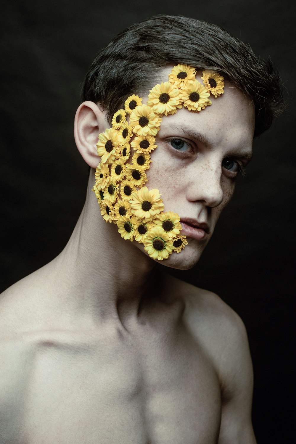 a man with sunflowers painted on his face