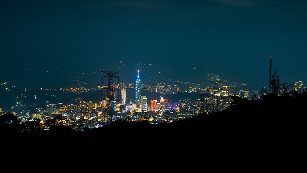 a view of a city at night from the top of a hill