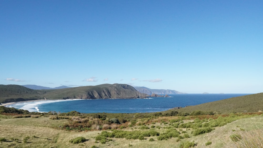 a scenic view of the ocean and mountains