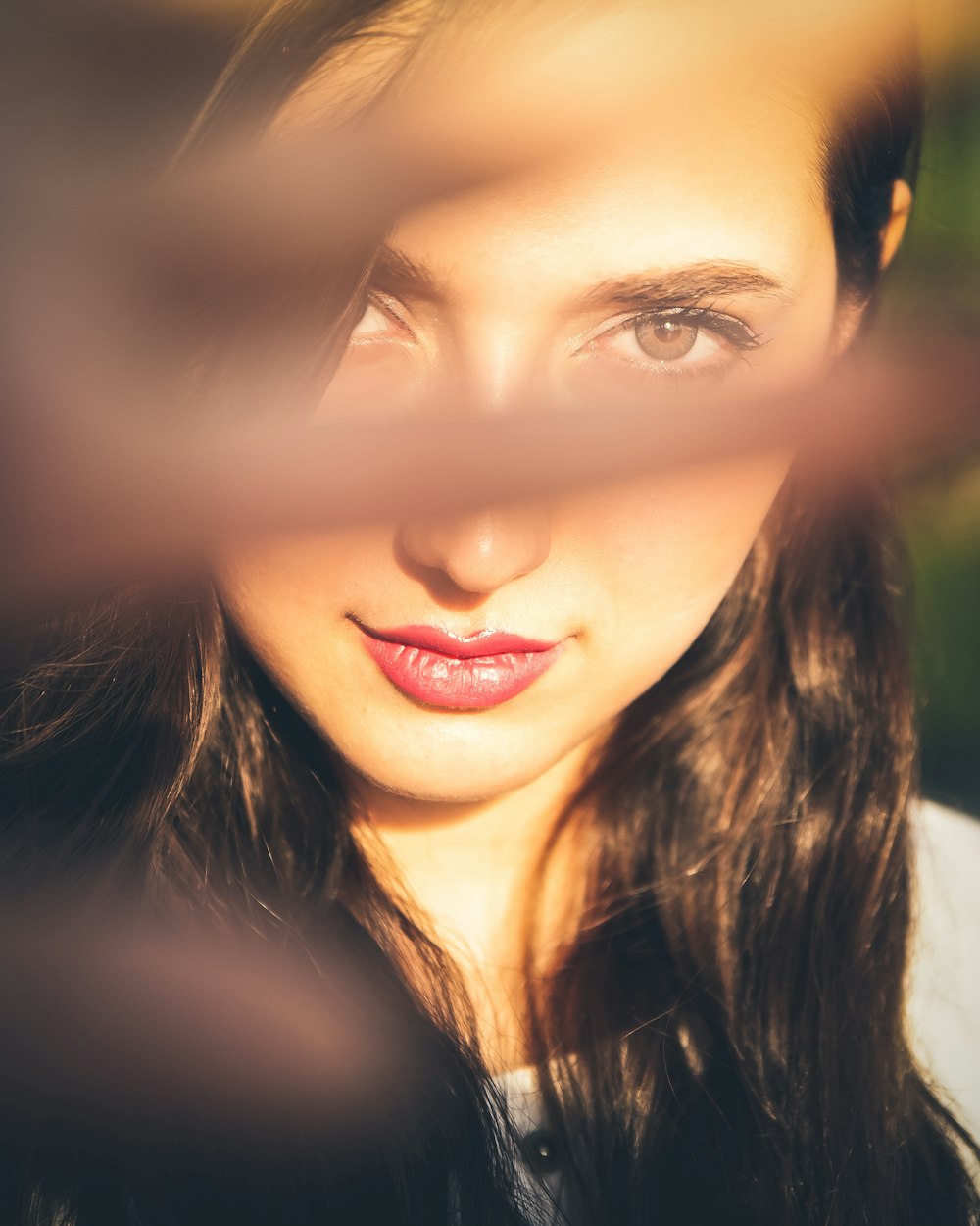 a close up of a woman's face with a blurry background