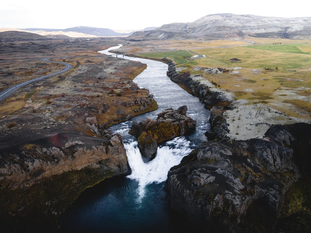 a river running through a lush green valley