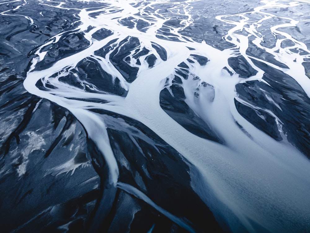 an aerial view of a river running through a mountain range