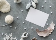 Flat lay of seasonal accessories paired with winter coats on a wooden surface.