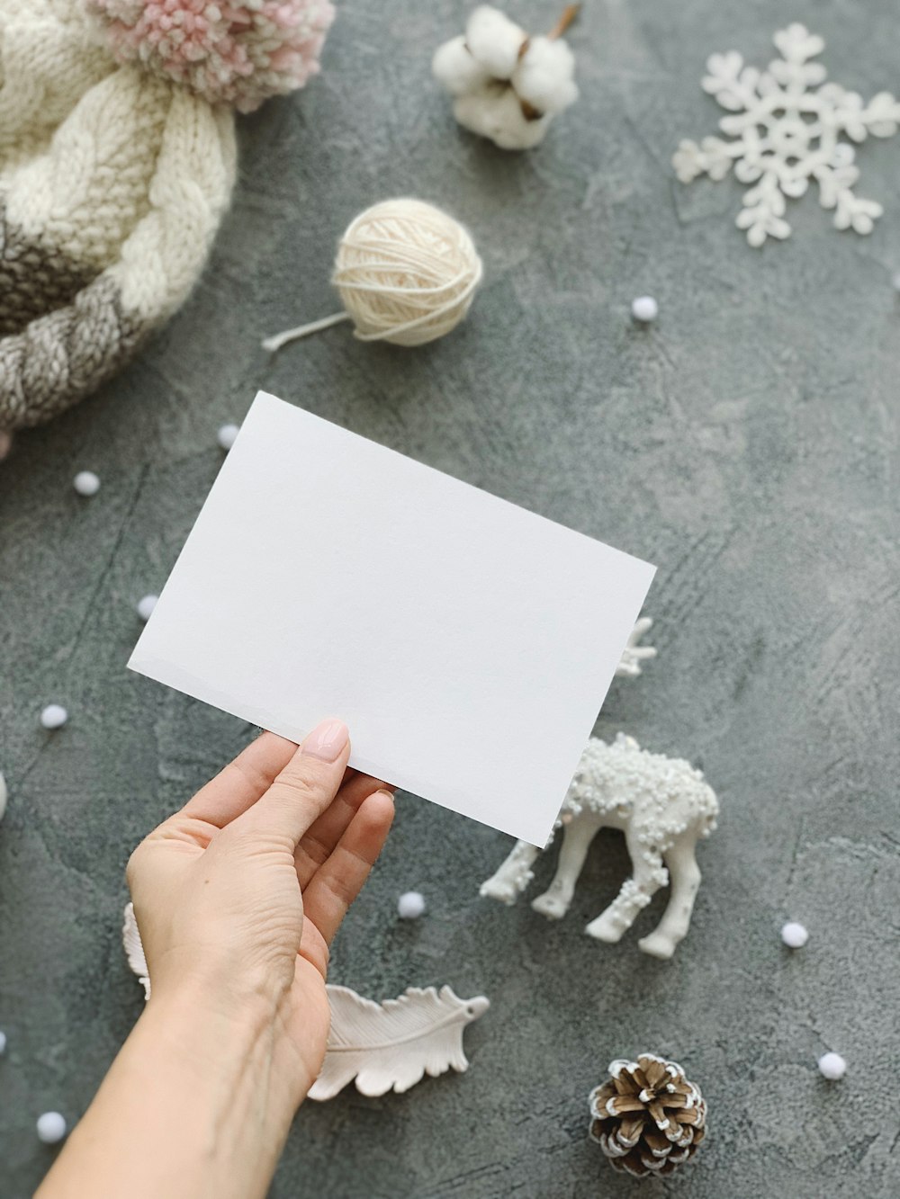 a person holding a piece of paper with a sheep on it