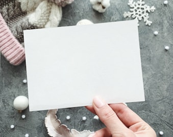 a person holding a piece of paper in their hand